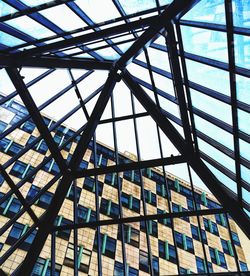 Low angle view of glass building against sky