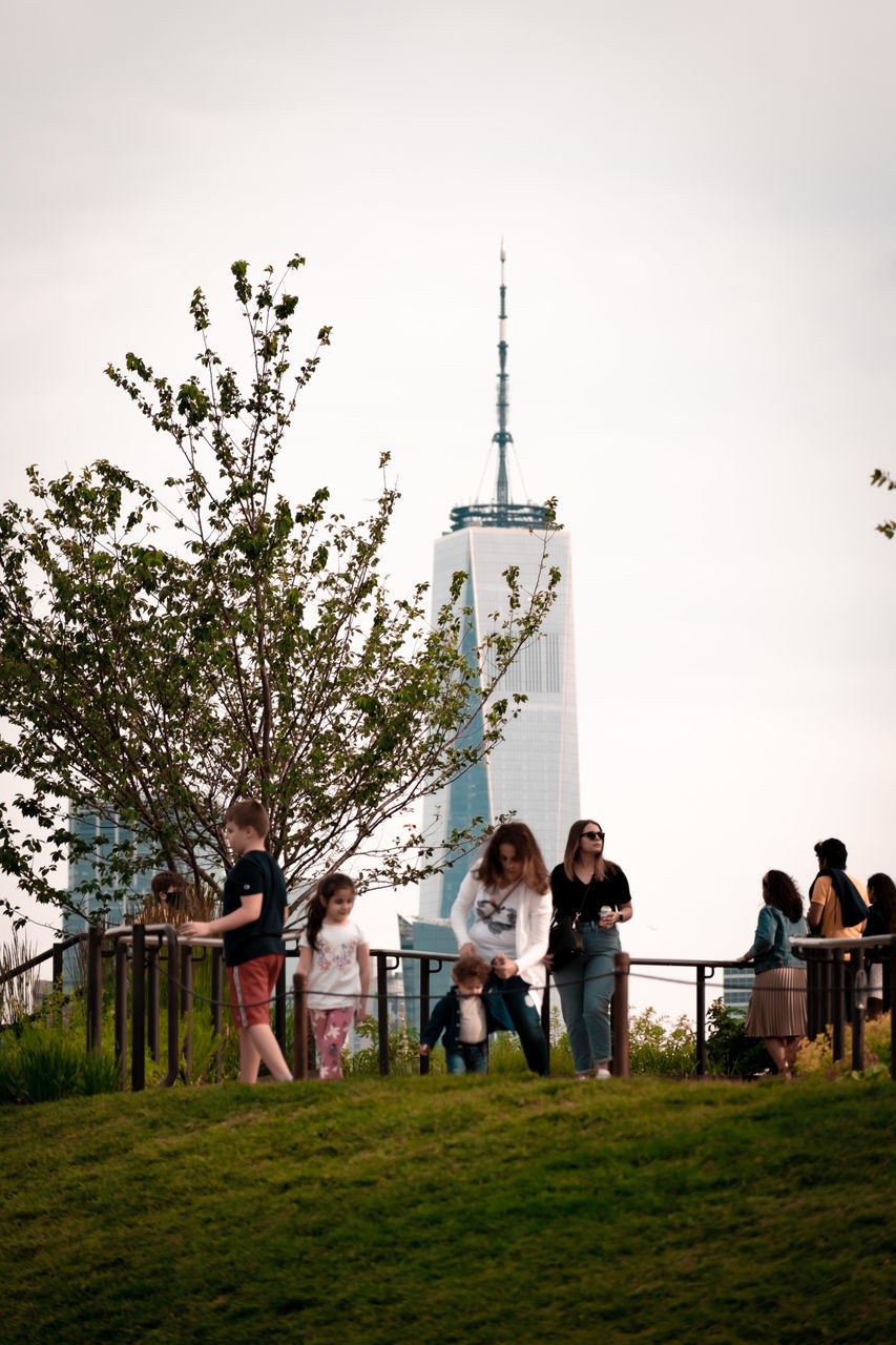 group of people, men, plant, nature, sky, architecture, tree, adult, women, grass, togetherness, group, child, medium group of people, crowd, childhood, outdoors, female, day, full length, built structure, building exterior, person, lifestyles, leisure activity