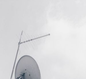 Low angle view of telephone pole against sky