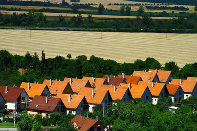 High angle view of houses and trees in city