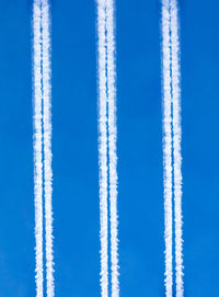 Aerial view of vapor trail in blue sky