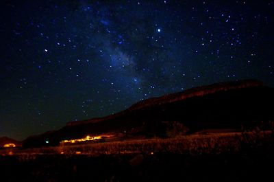 Scenic view of silhouette mountain against sky at night