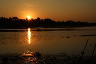 Scenic view of lake against sky during sunset