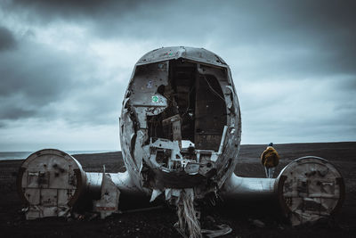 Abandoned truck on land against sky