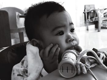 Close-up of cute baby boy with toy at table