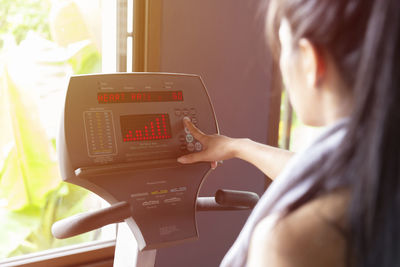 Woman using treadmill in gym