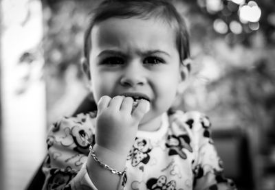 Portrait of cute baby girl eating food at home