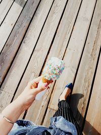 Low section of person holding food on cutting board