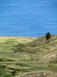 Scenic view of landscape and sea against sky