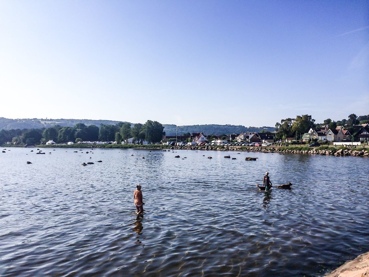 water, clear sky, copy space, waterfront, blue, building exterior, sea, rippled, river, nautical vessel, built structure, scenics, architecture, nature, city, tranquility, leisure activity, mountain, transportation