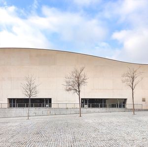 Exterior of sport complex against cloudy sky