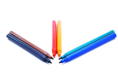 Close-up of colored pencils over white background