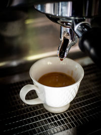 Close-up of coffee cup on machine