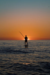 Standup paddle on sunset