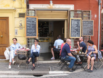 Group of people sitting in front of building