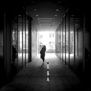 Full length of woman walking on footpath