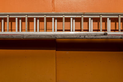 Metallic structure on orange wall