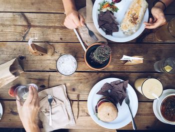 Cropped hands having food on table