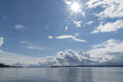 Sunburst over the salish sea with passing ferry boat.