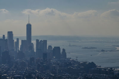 View of cityscape against cloudy sky