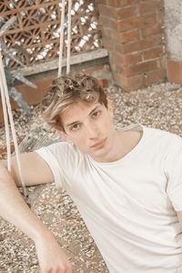 Portrait of young man sitting outdoors