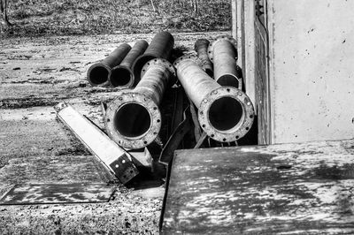 Abandoned pipes against wall
