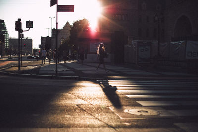 Shadow of man on city street at sunset