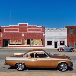 Vintage car on street against blue sky