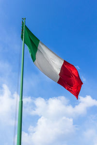 Low angle view of italian flag against blue sky