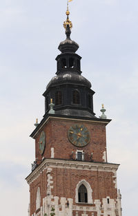 Low angle view of clock tower against sky