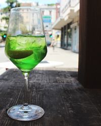 Green drink in glass on table