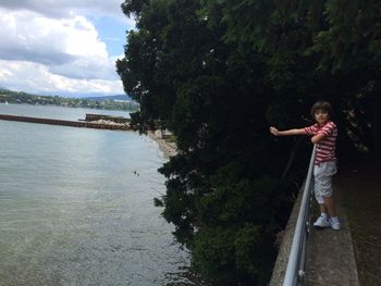 Boy standing on observation point by lake geneva