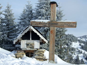 Built structure on snow covered land against sky