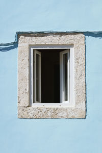 Low angle view of window on wall of building