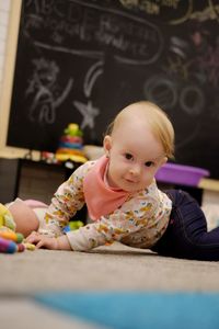Portrait of cute baby girl crawling at home