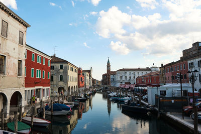 Boats moored at harbor in a canal, sottomarina di chioggia, venice