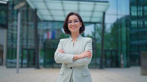 Portrait of gorgeous dark haired business leadership woman smiling charmingly 