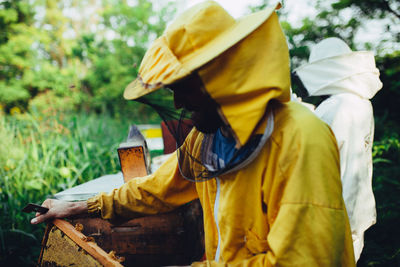 Beekeepers standing by beehives