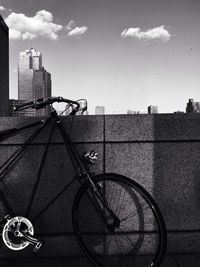 Bicycle on city against sky