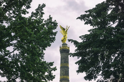 Low angle view of statue against cloudy sky