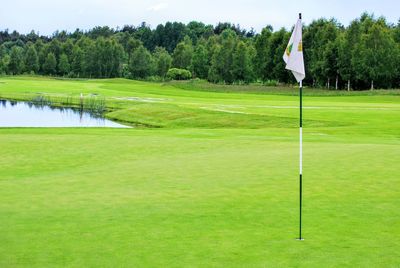 Scenic view of golf course against sky