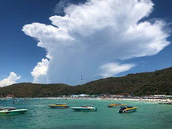 Boats moored on sea against sky