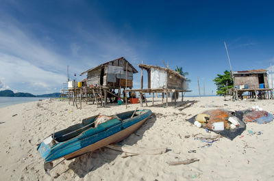 Lifeguard hut on beach against blue sky