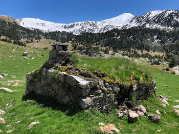 Scenic view of refuge with chimney at the mountain against sky