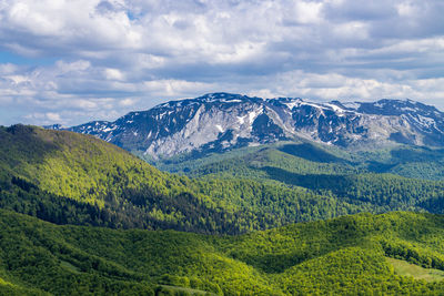 Scenic view of landscape and mountains against sky