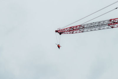 Low angle view of crane against clear sky