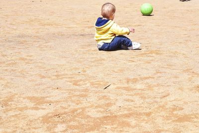 Baby boy playing with ball at playground