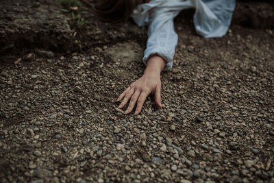 Womans hand on ground