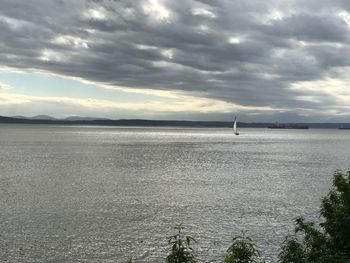 Sailboat sailing on sea against sky