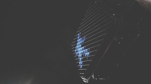 Close-up of illuminated lighting equipment against black background